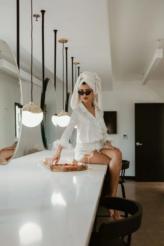A bride sits in a robe with a towel over her hair in our bridal suite