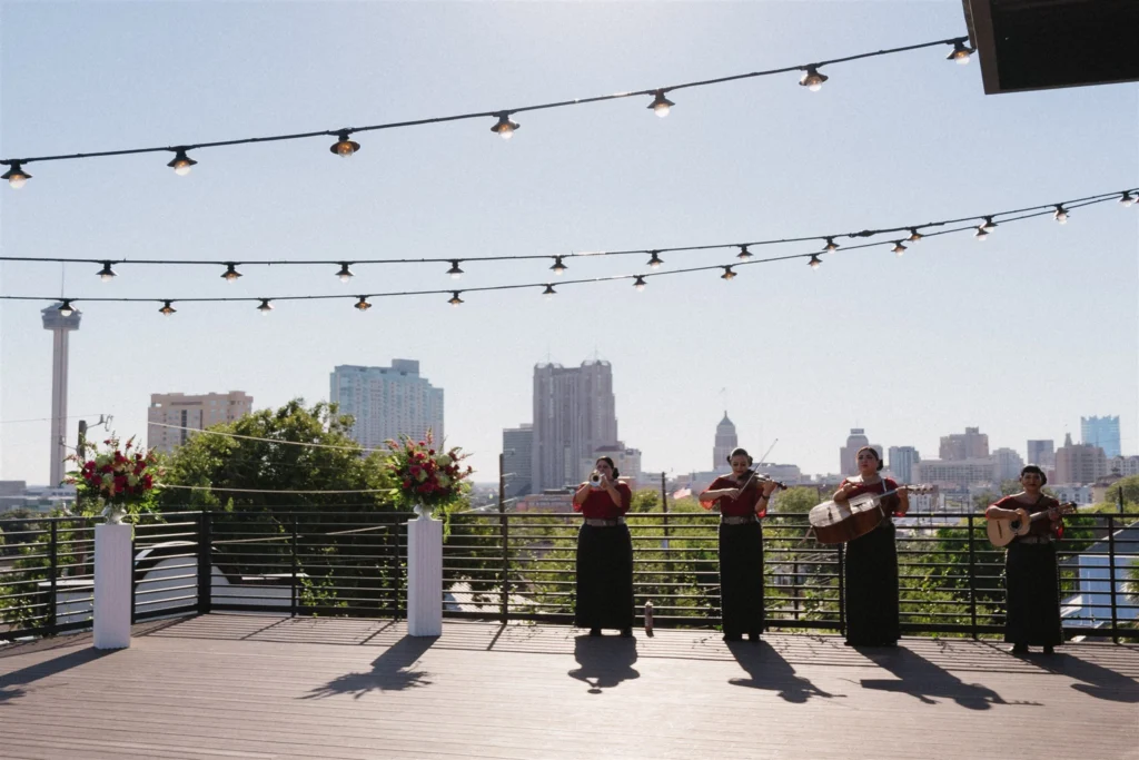 A band plays music in front of the San Antonio skyline