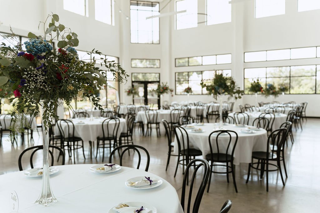 Round tables with floral arrangements in the Skyline event space