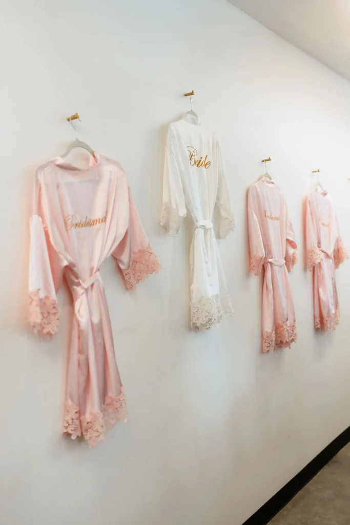 Bride and Bridesmaid robes hang on the wall of our dressing suite