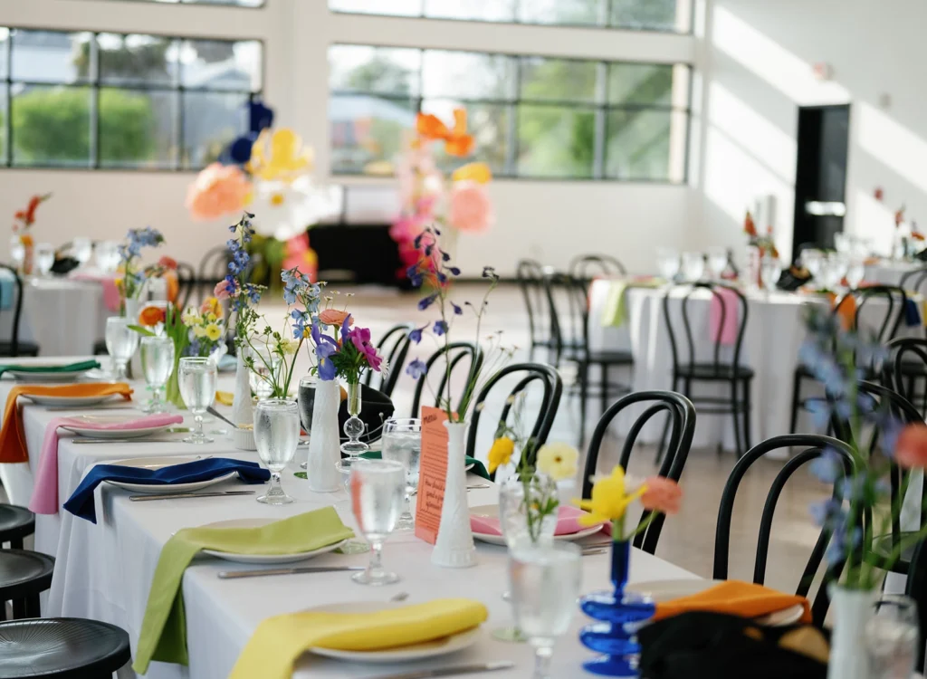 Colorful place settings and floral arrangements adorn the tables in the Skyline's event space