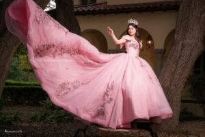 A young woman in a pink gown and tiara